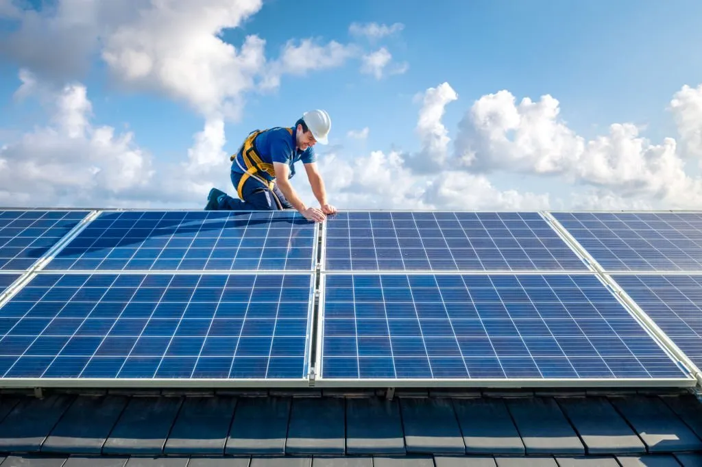 A man Adjusting Solar Energy Panels